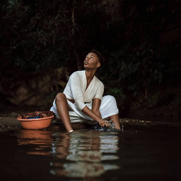 Black woman looking up into the sky modeling