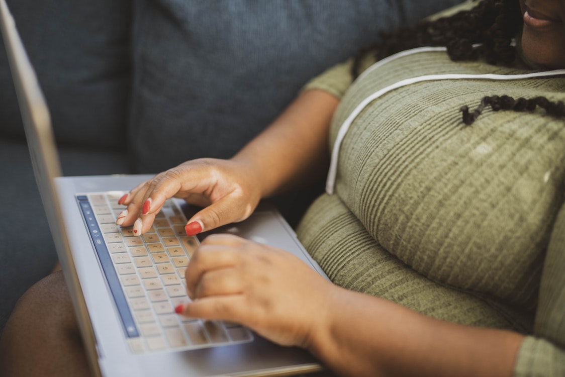 Woman's Fingers on Laptop Keyboard